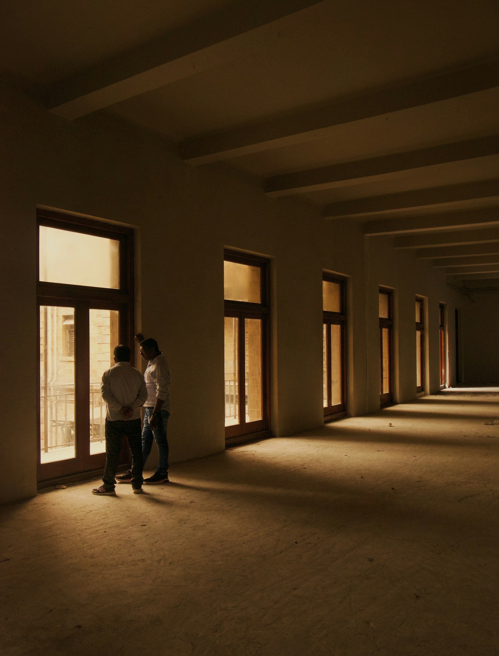 A couple viewing a bright, empty new apartment, imagining their life there