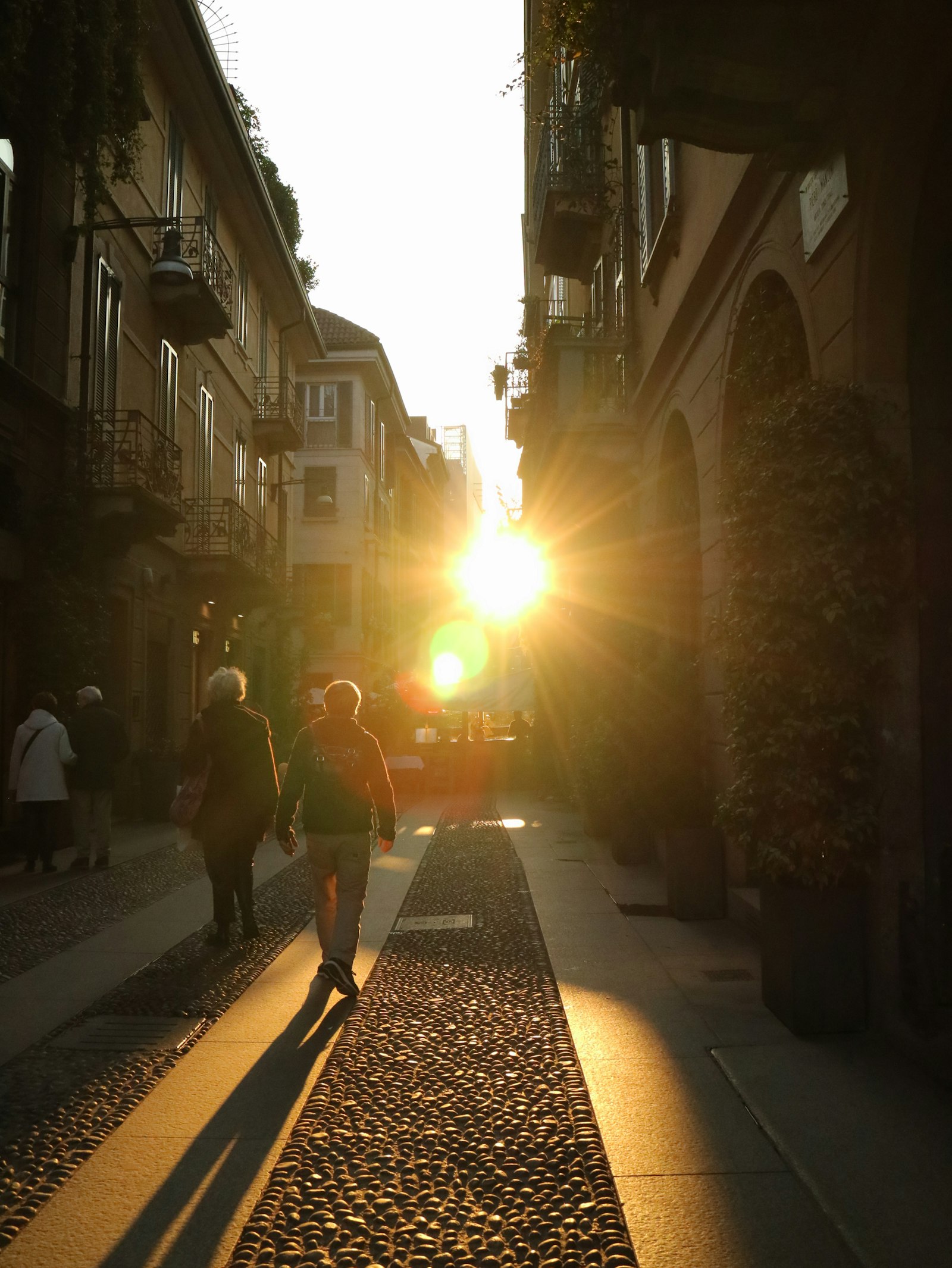 A new arrival being met on a sunny foreign street, warmly welcomed on their first day
