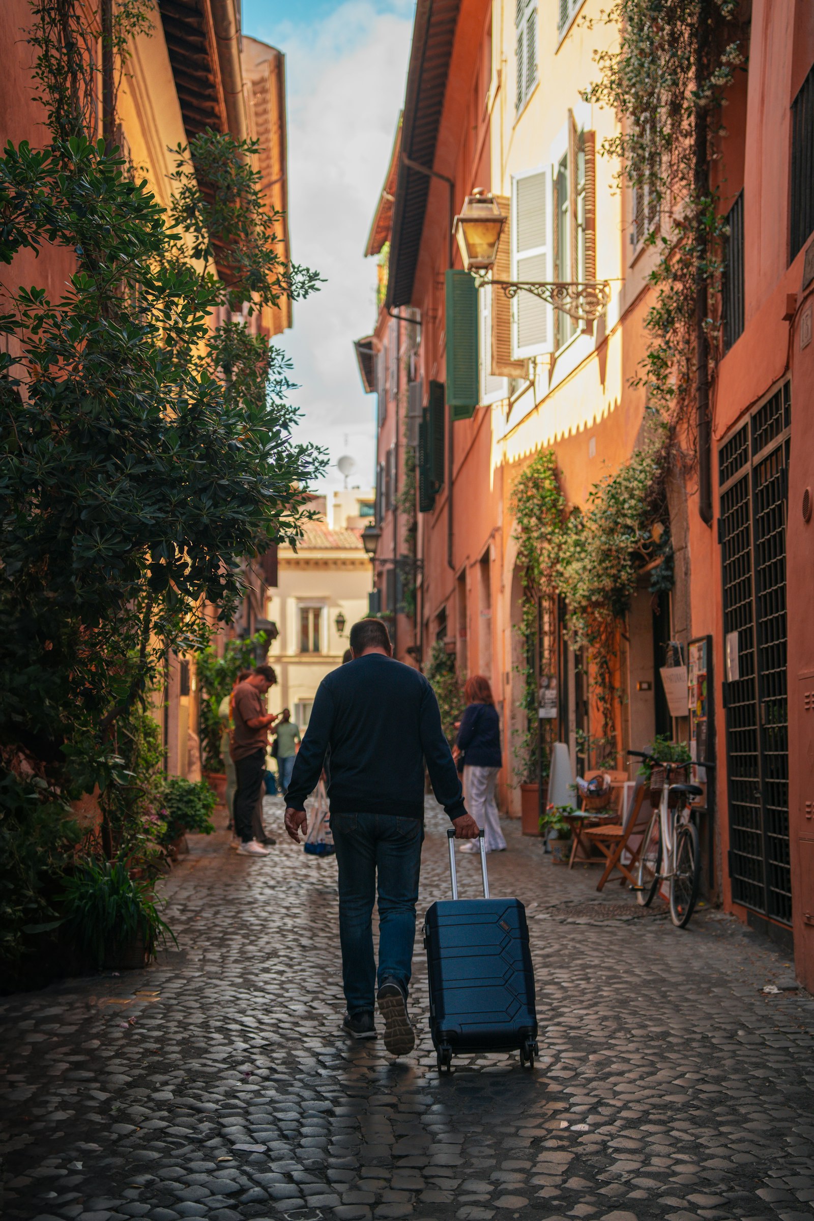 A couple arriving in a sunlit new city with their luggage, looking ahead with anticipation